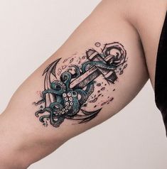 an octopus and ship tattoo on the arm