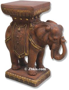 an elephant statue sitting on top of a table