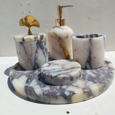 marble bathroom accessories including soap dispenser and toothbrush holder