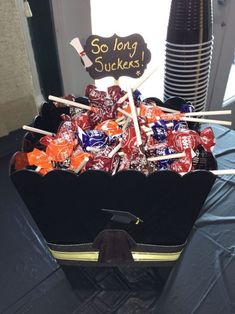 a suitcase filled with lots of candy on top of a table