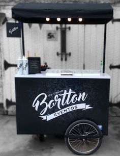 a black and white photo of an ice cream cart with the word boston written on it