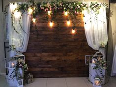 a wooden wall decorated with flowers and candles