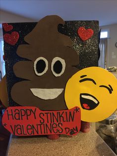 a couple of emoticions are holding up valentine's day greetings on a table