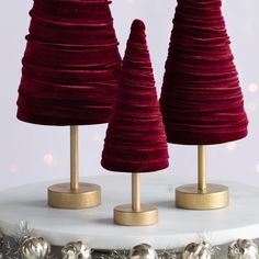 two red christmas trees on top of a white cake