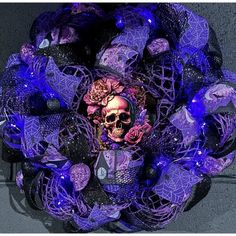 a purple and black wreath with a skull on it