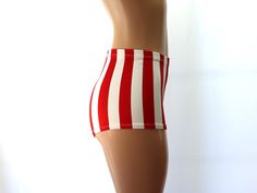 These red and white stripes are 1" wide and the spandex fabric is very stretchy to ensure a comfortable fit.  They are high waisted and sport a flirty cheeky backside.   SIZING INFO ⭐Sizing Chart in Photos⭐ If you need help with sizing, send me a message and please include the following measurements: ✅NATURAL WAIST ✅HIPSTER WAIST ✅HIPS ✅Thigh ⭐Inquire within for Adult 6X and up. CUSTOM REQUESTS 👉Need the waist higher/lower? 👉Inseam longer/shorter? 👉Love this style but not the fabric or color?   👉Love this fabric and color but not this style?  💌Just message me with your ideas and I will be happy to make some custom duds just for you! GARMENT CARE ☔Please gently hand wash in cold water with chlorine-free mild detergent and line dry to extend the life of your new duds.  👚Please iron on Fitted Bottoms With Vertical Stripes For Summer, Retro Striped Fitted Bottoms, Red Vertical Stripes Bottoms For Summer, Red Vertical Stripes Summer Bottoms, Retro White Fitted Shorts, Candy Cane Costume, Pole Fitness, Long Shorts, Red And White Stripes