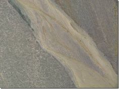 an aerial view of a mountain with snow on the ground