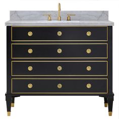 a black and white vanity with gold accents on it's drawers, sink and faucet