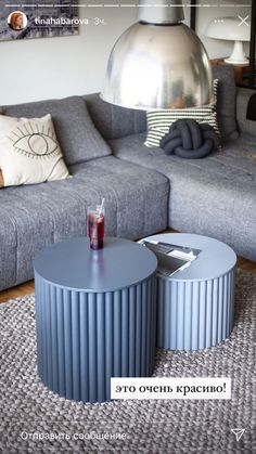 a living room filled with furniture and a large metal light fixture above the coffee table