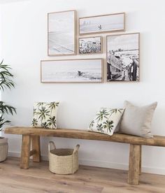 a wooden bench sitting in the middle of a living room next to a potted plant