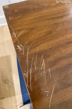 the top of a wooden table with white paint on it