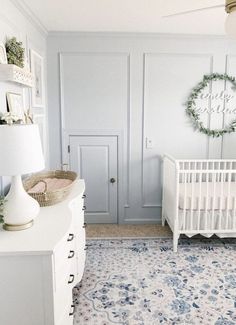 a baby's room with a crib, dresser and bed