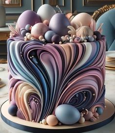 a colorful cake decorated with eggs and swirls on a white tableclothed surface