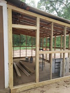 the inside of a chicken coop is being built with wood and wire mesh on top