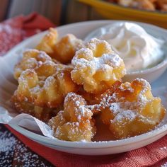 small desserts are served in white bowls with powdered sugar on top