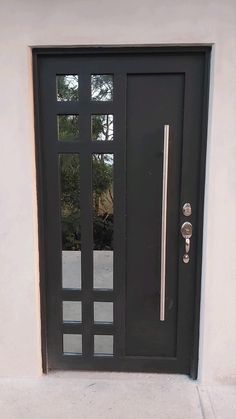 a black front door with glass and metal handle