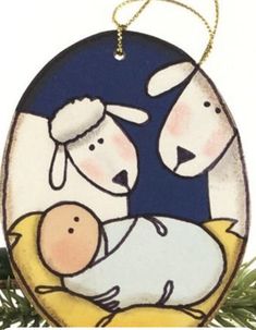 a christmas ornament with two sheep and a baby