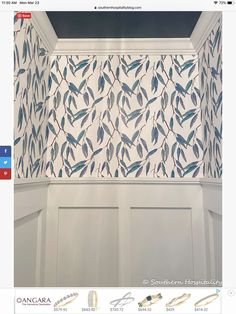 a bathroom with blue and white leaves on the wall