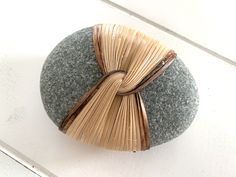 a rock with a ribbon on it sitting on a table