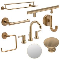 an assortment of brass bathroom accessories including soap dispenser, mirror and towel bar