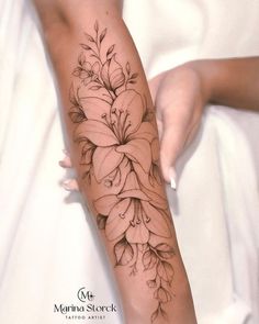 a woman's arm with flowers on it