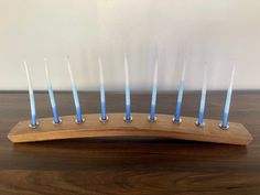 a wooden stand with blue candles on it