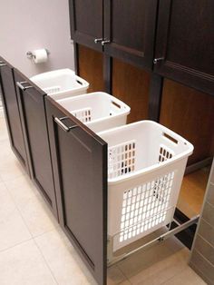 two laundry baskets sitting in the middle of a kitchen