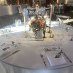 the table is set with silverware, napkins and place settings for an event