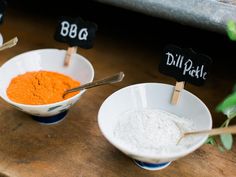 three bowls filled with different types of food on top of a wooden table next to each other