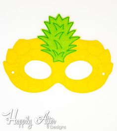 a yellow mask with a green pineapple on the top, and words happily aftn