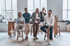 group of people sitting around a table in an office