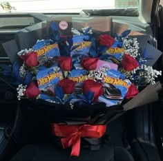 a bouquet of candy and roses in the back seat of a car