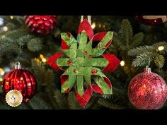 a christmas ornament hanging from the side of a tree with ornaments around it