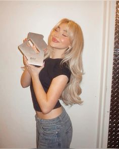 a woman is holding an award in front of her face