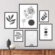 black and white art prints on the wall above a dresser in a modern living room