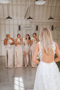 a bride and her bridal party in the barn