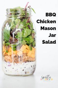 a mason jar filled with salad on top of a table