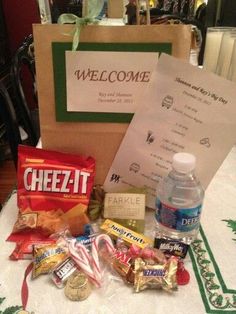 an assortment of candy and snacks on a table with a welcome sign in the background