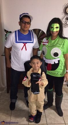 two adults and a child dressed up in costumes