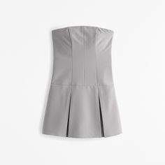 Elevate your wardrobe with the Abercrombie & Fitch Women's Strapless Pleated Skort in an elegant Frost Gray. This chic piece combines the allure of a skirt with the practicality of shorts, making it a versatile addition to your collection.

- Size: L Petite
- Color: Frost Gray
- Material: Bodice - Polyester, Elastane; Lining - Polyester, Elastane
- Gender: Female
- Age Group: Adult

Designed with a slim bodice and gracefully pleated skirt, this skort features built-in hidden shorts for comfort a Fitted Short Length Tube Top For Summer, Fitted Tube Top For Summer, Fitted Crop Tube Top For Summer, Suits Coats, Swimwear Accessories, Polished Look, Women's Dresses, Jacket Tops, Modern Woman