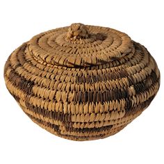 a brown and tan woven basket on a white background