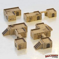 six small model houses sitting on top of a table