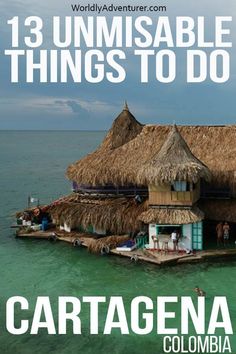 an island with thatched huts and people standing on it