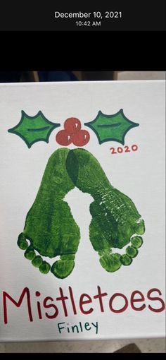 a handprinted christmas card with holly leaves and mistletoes on it