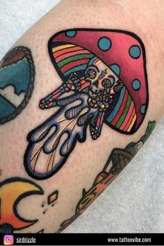 a colorful tattoo on the arm of a person with a mushroom hat and other items