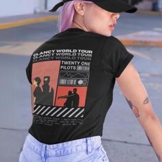 a woman with pink hair wearing a black hat and t - shirt that says planet world tour