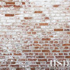 an old brick wall with white and red paint