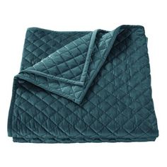 the teal quilted blanket is folded up