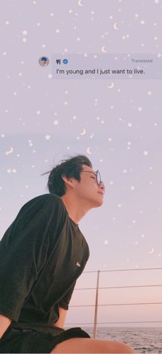 a man sitting on top of a boat under a sky filled with stars and moon