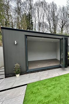 Modern stone grey garden room situated in a beautifully landscaped garden, offering a stylish and functional space for various uses like a home office, gym, or relaxation retreat. External Wall Cladding, Landscaped Garden, Office Gym, Grey Exterior, Grey Gardens, Stone Grey, Garden Office